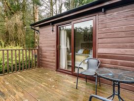 An outdoor area with a chair and table at Cabin 1 Moffat Manor in Beaufort