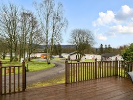 An outdoor view from a deck overlooking caravans and trees at Cabin 1 Moffat Manor Beaufort