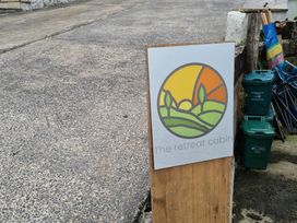 A sign for The Retreat Cabin outdoors in Llanelli
