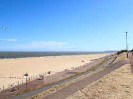 A beach with a path and people walking at Cootiya Corner in Great Lyth