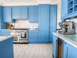 A kitchen with blue cabinets and stainless steel appliances at Cootiya Corner in Great Lyth