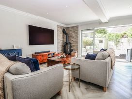 A living room with a fireplace and a television at Cootiya Corner, Great Lyth