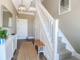 A hallway with a staircase and a bench at Cootiya Corner Great Lyth