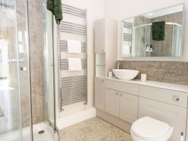 A bathroom with a shower, sink, toilet, and towel rail at Cootiya Corner, Great Lyth