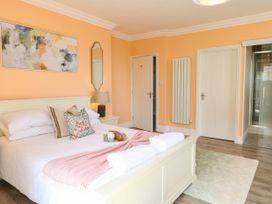 A bedroom with a bed, bedside table, and a mirror at Cootiya Corner in Great Lyth