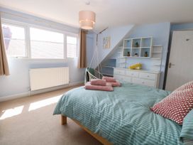 A bedroom with a bed and shelves at Cootiya Corner in Great Lyth