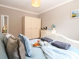 A bedroom with a bed and wardrobe at Cootiya Corner in Great Lyth