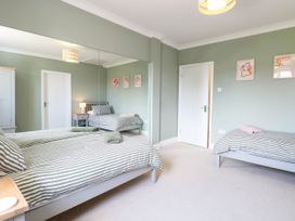 A bedroom with two beds and a wardrobe at Cootiya Corner in Great Lyth