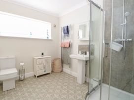 A bathroom with a shower, toilet, sink, and towel rack at Cootiya Corner in Great Lyth