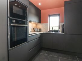 A kitchen with appliances and countertop at Seren Fach Pwllheli