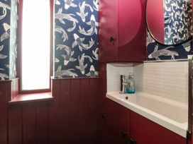 A bathroom with a sink and mirror at Seren Fach in Pwllheli