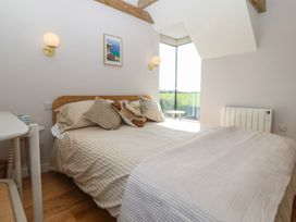 A bedroom with a bed and a window at Seren Fach in Pwllheli