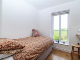 A bedroom with a bed and window at Seren Fach in Pwllheli