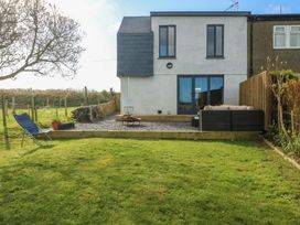 A house with windows and a patio in the outdoor area at Seren Fach Pwllheli
