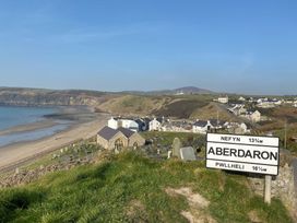 A coastal scene with a sign and graves at Seren Fach near Aberdaron