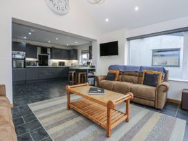 A living room with a sofa and coffee table at Benlli in Pwllheli