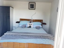 A bedroom with a bed and a wardrobe at The lodge at Plumstone View in Haverfordwest
