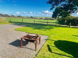 A grill on gravel with grass and a field at The lodge at Plumstone View Haverfordwest