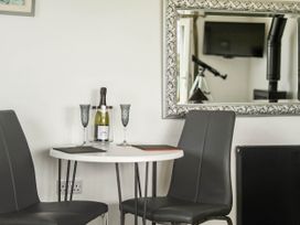 A dining area with champagne on the table at The lodge at Plumstone View Letterston