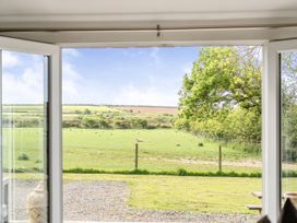 A view of fields and trees through a window at The lodge at Plumstone View in Letterston