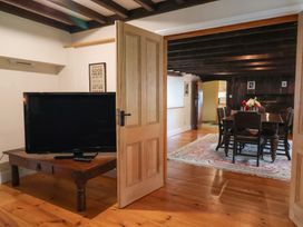 A dining room with a wooden table and chairs at Ellishayes Farm in Combe Raleigh