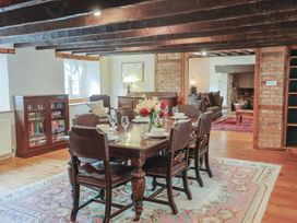 A dining room with a wooden table and chairs at Ellishayes Farm in Combe Raleigh
