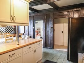 A kitchen with cabinets and a table at Ellishayes Farm in Combe Raleigh