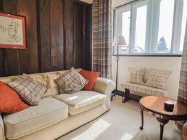 A living room with a sofa and side table at Ellishayes Farm in Combe Raleigh
