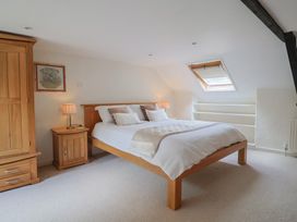 A bedroom with a bed and bedside tables at Ellishayes Farm in Combe Raleigh
