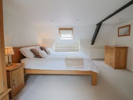 A bedroom with a bed and bedside furniture at Ellishayes Farm in Combe Raleigh