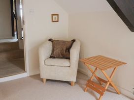 A chair and a side table in a living room at Ellishayes Farm Combe Raleigh