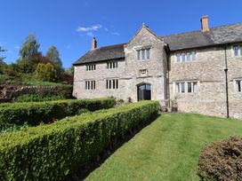 A stone building with a garden at Ellishayes Farm Combe Raleigh