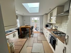 A kitchen with table and chairs at Penderyn Cottage Aberdare
