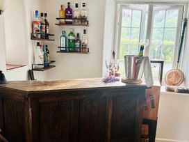 A bar with bottles and glasses at The Bark House in Tiverton