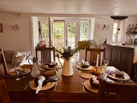 A dining room with a table set for a meal at The Bark House in Tiverton