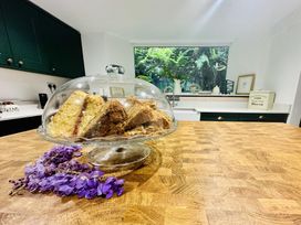 A cake stand with cakes on a kitchen counter at The Bark House in Tiverton