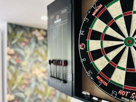 A dartboard and darts with scoreboard at The Bark House in Tiverton