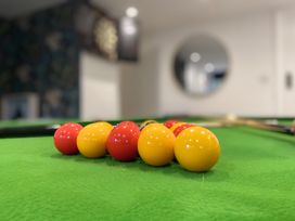 A game room with pool balls on a table at The Bark House in Tiverton