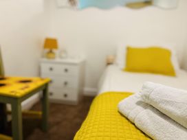 A bedroom with a bed and towels at The Bark House in Tiverton