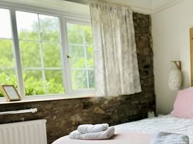 A bedroom with bed and towels arranged at The Bark House in Tiverton