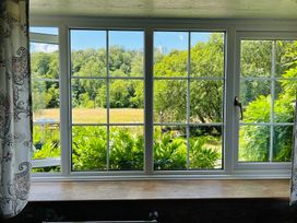 A window with a view of greenery and fields at The Bark House in Tiverton