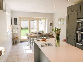 A kitchen with table and chairs in an open layout at East View Cheltenham