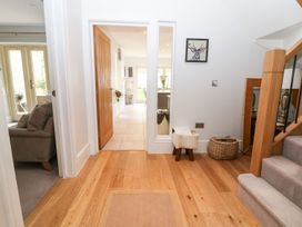 A hallway with stairs and a sofa at East View in Cheltenham