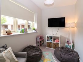 A playroom with bean bags and a television at East View in Cheltenham