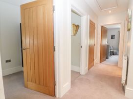 A hallway with multiple doors and a radiator at East View in Cheltenham