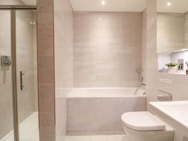 A bathroom with a bathtub and shower at East View in Cheltenham