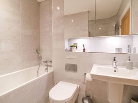 A bathroom featuring a bathtub, toilet, and sink at East View in Cheltenham