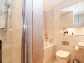 A bathroom with a shower, bathtub, toilet, and sink at East View in Cheltenham