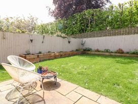 A garden with raised flower beds and a chair at East View in Cheltenham
