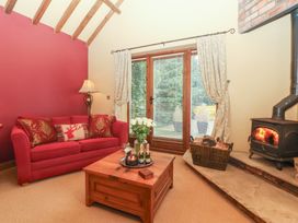 A living room with a sofa, coffee table, and fireplace at Champagne Cottage in Malton